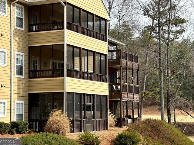 a front view of a house with a tree