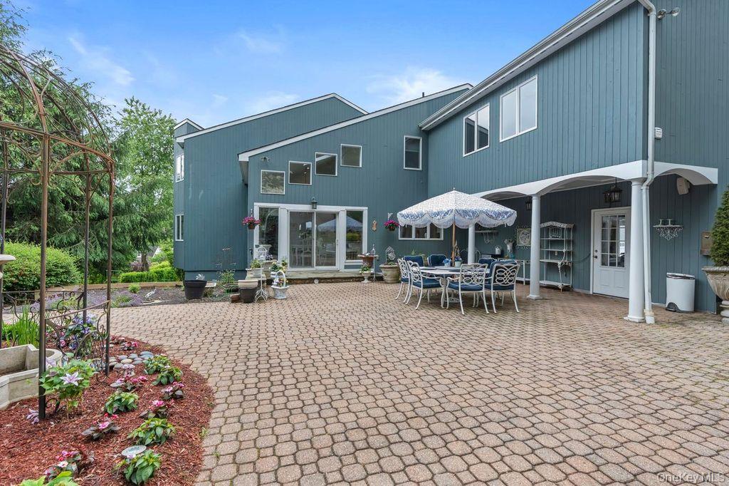 266 Shear Hill Road Mahopac, NY 10541 - Photo 22 of 34 a patio with a table and chairs and potted plants