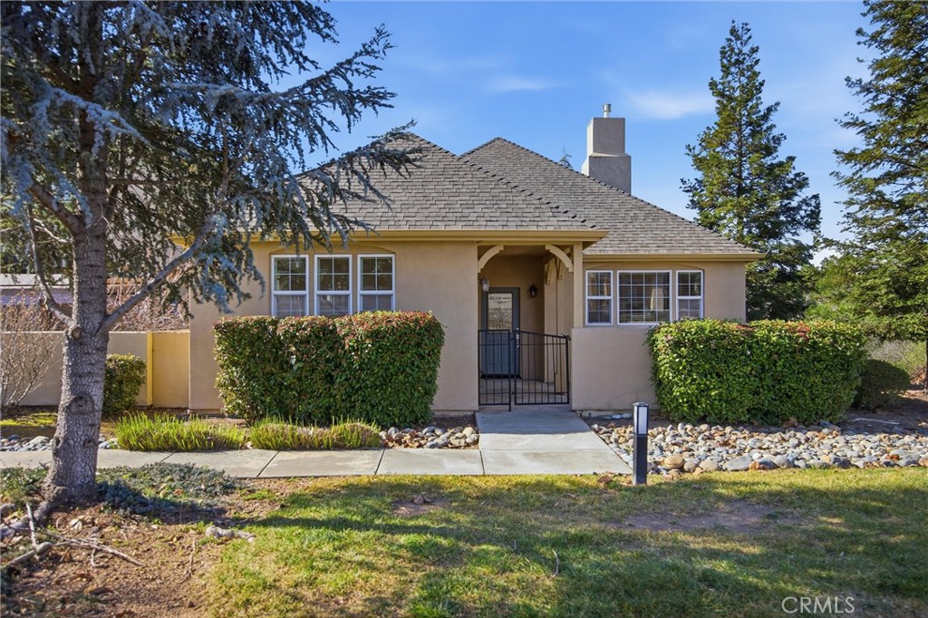 93 Benson Terrace Chico, CA 95928 - Photo 1 of 15 a front view of a house with a yard and potted plants