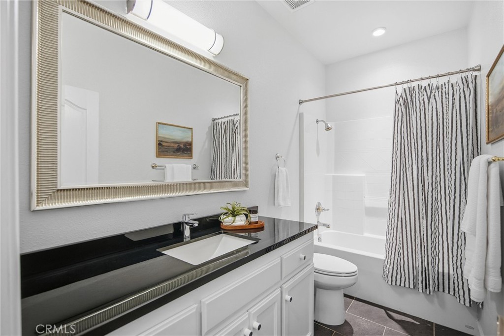 93 Benson Terrace Chico, CA 95928 - Photo 14 of 15 a bathroom with a sink a toilet a mirror and shower