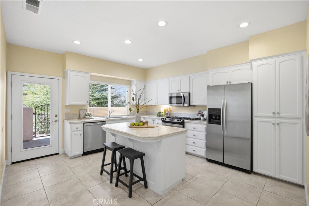 93 Benson Terrace Chico, CA 95928 - Photo 3 of 15 a kitchen with a sink a refrigerator and chairs