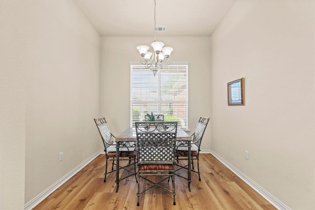 2821 Fordham Road Plano, TX 75025 - Photo 14 of 40 a view of a dining room with furniture a chandelier and wooden floor