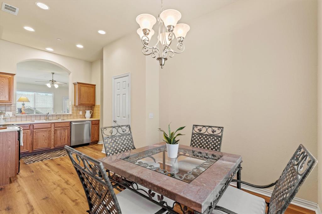 2821 Fordham Road Plano, TX 75025 - Photo 16 of 40 a view of a dining room with furniture a chandelier and wooden floor