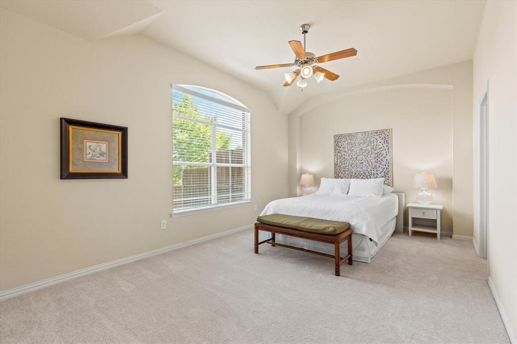 2821 Fordham Road Plano, TX 75025 - Photo 17 of 40 a spacious bedroom with a bed and a chandelier