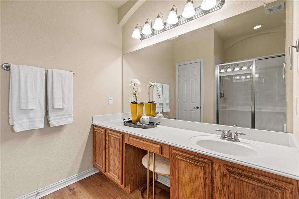 2821 Fordham Road Plano, TX 75025 - Photo 22 of 40 a bathroom with a sink double vanity and a mirror