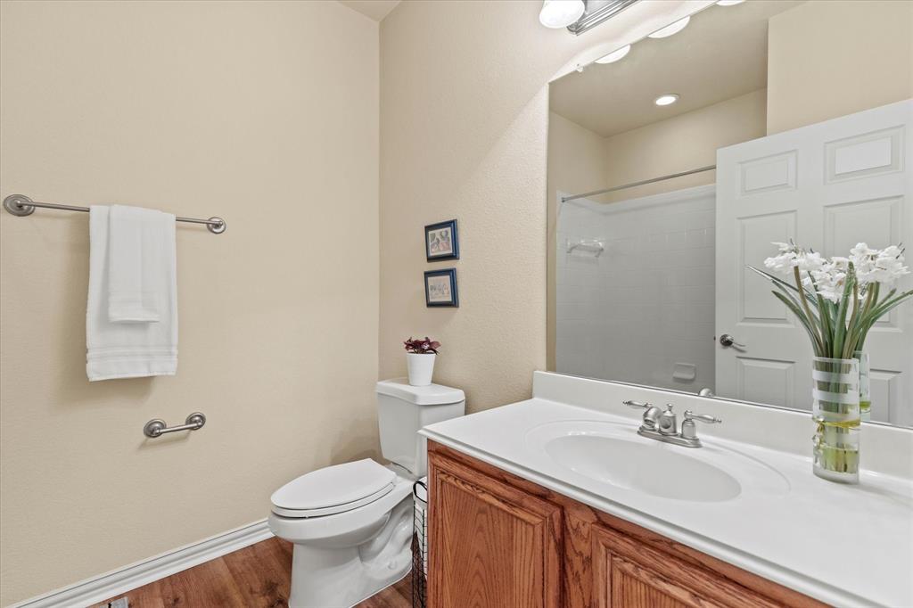 2821 Fordham Road Plano, TX 75025 - Photo 26 of 40 a bathroom with a sink a toilet and mirror