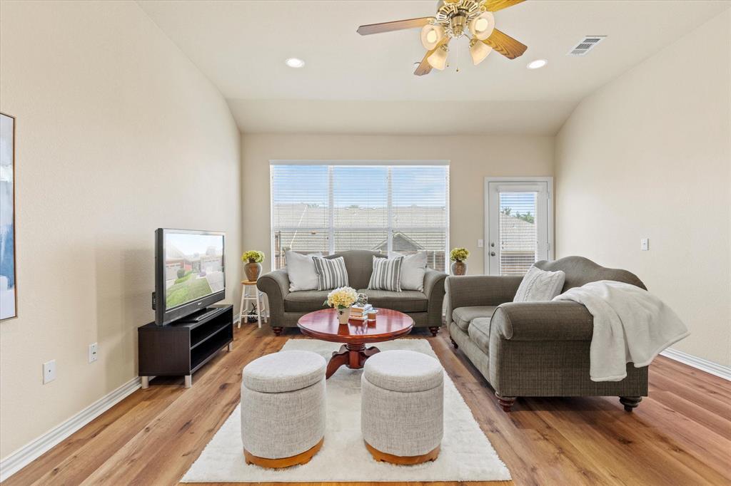 2821 Fordham Road Plano, TX 75025 - Photo 6 of 40 a living room with furniture a flat screen tv and a large window