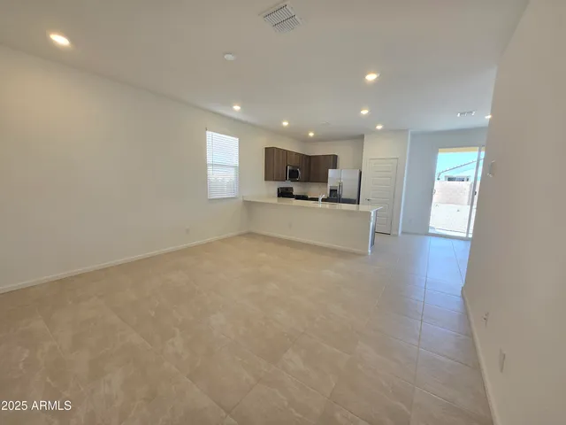 a view of a kitchen with a sink a microwave and wooden floor