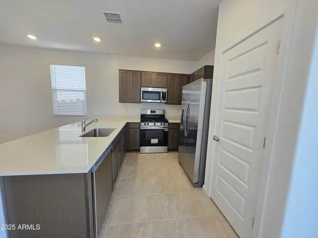 a kitchen with refrigerator and cabinets