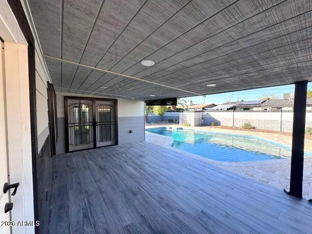 a room with wooden floors and couch