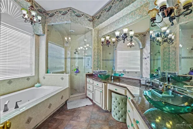 a spacious bathroom with a double vanity sink a large mirror and a bathtub