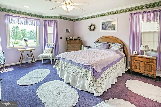 a bed room with a bed and a chair