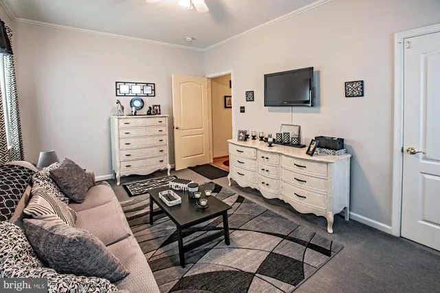 a bedroom with furniture and a flat screen tv