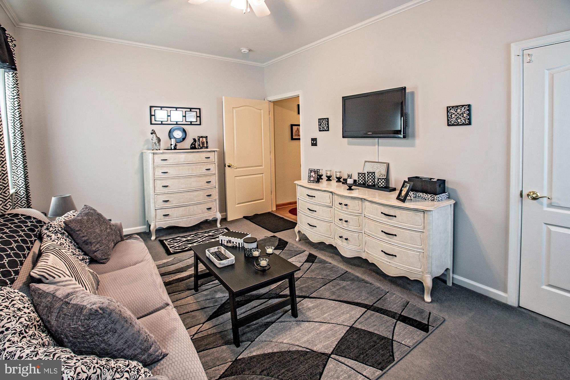 7 Meghans Way Pennsville, NJ 08070 - Photo 24 of 30 a bedroom with furniture and a flat screen tv