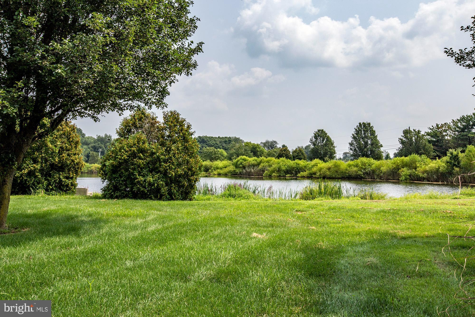 7 Meghans Way Pennsville, NJ 08070 - Photo 28 of 30 a view of a lake with houses in the back