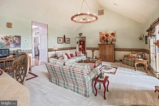 a bedroom with furniture and a chandelier