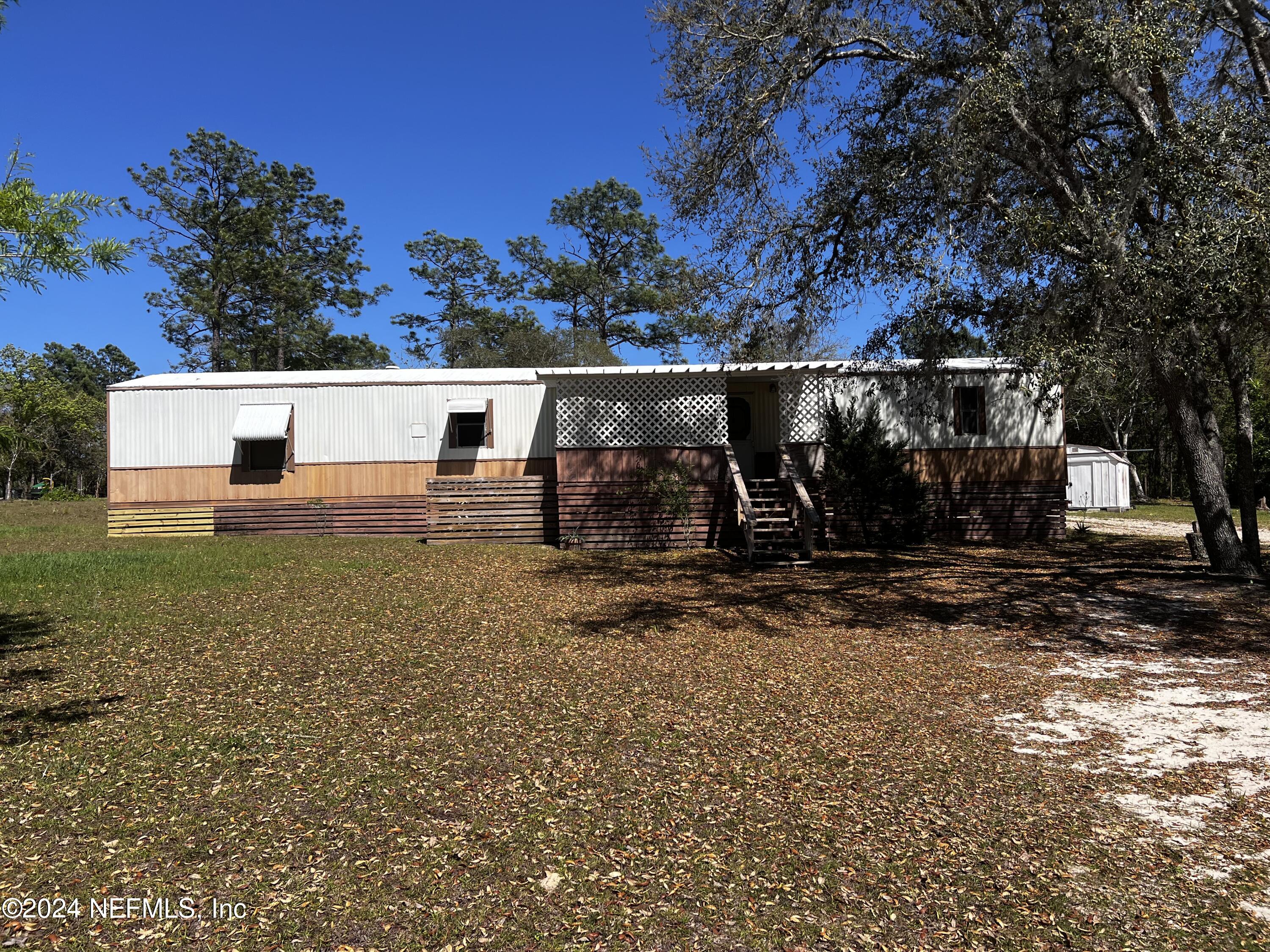 a view of house with backyard space and garden