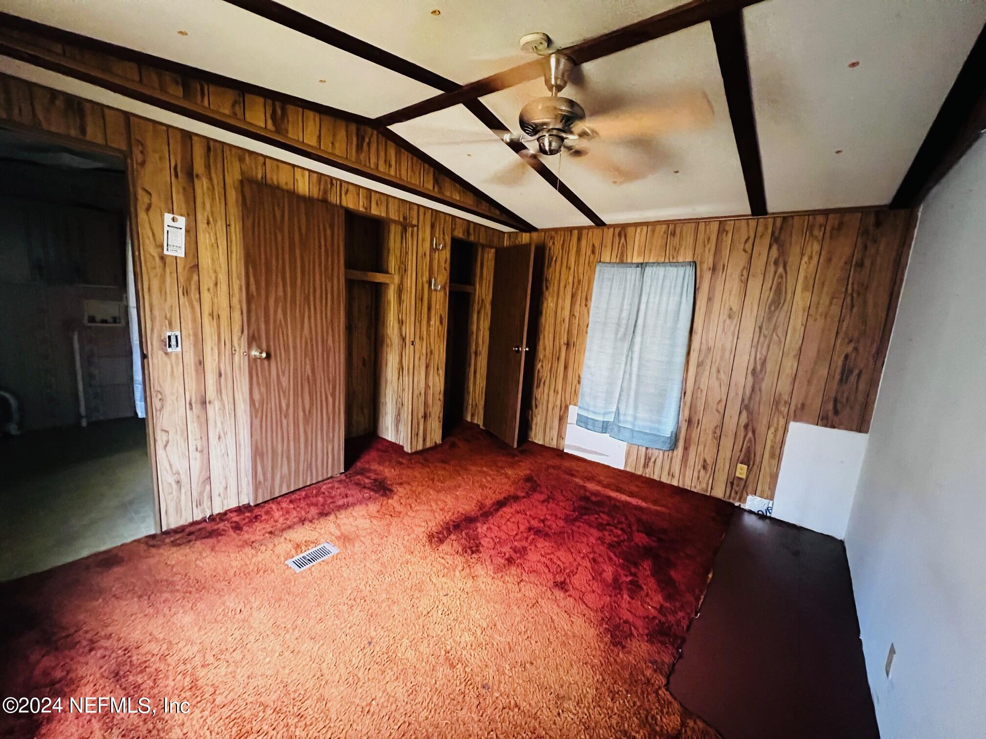 7635 Oak Forest Road Keystone Heights, FL 32656 - Photo 13 of 30 a bedroom with a bed and a mirror
