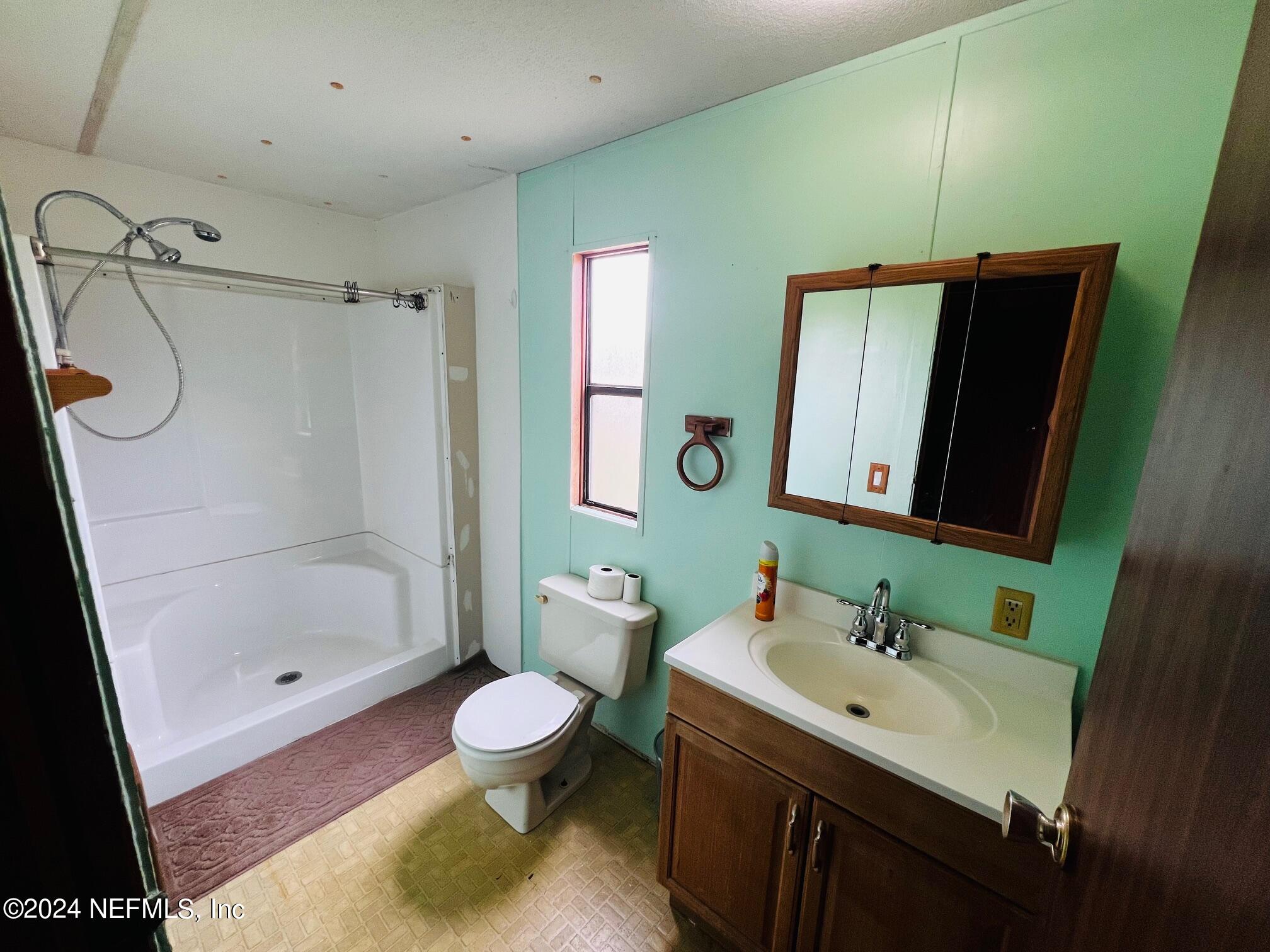 7635 Oak Forest Road Keystone Heights, FL 32656 - Photo 14 of 30 a bathroom with a sink toilet and shower