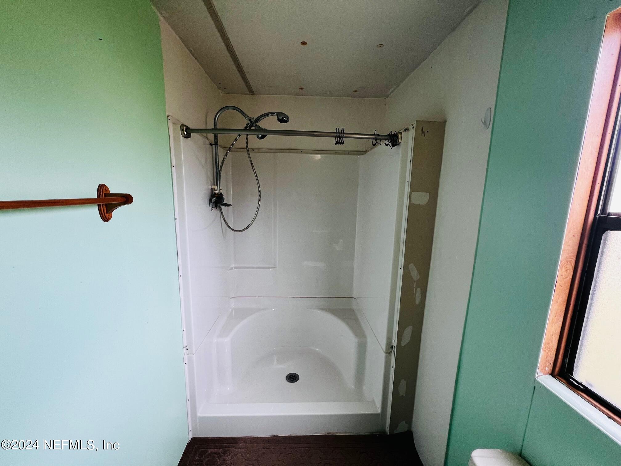 7635 Oak Forest Road Keystone Heights, FL 32656 - Photo 15 of 30 a bathroom with a glass shower door