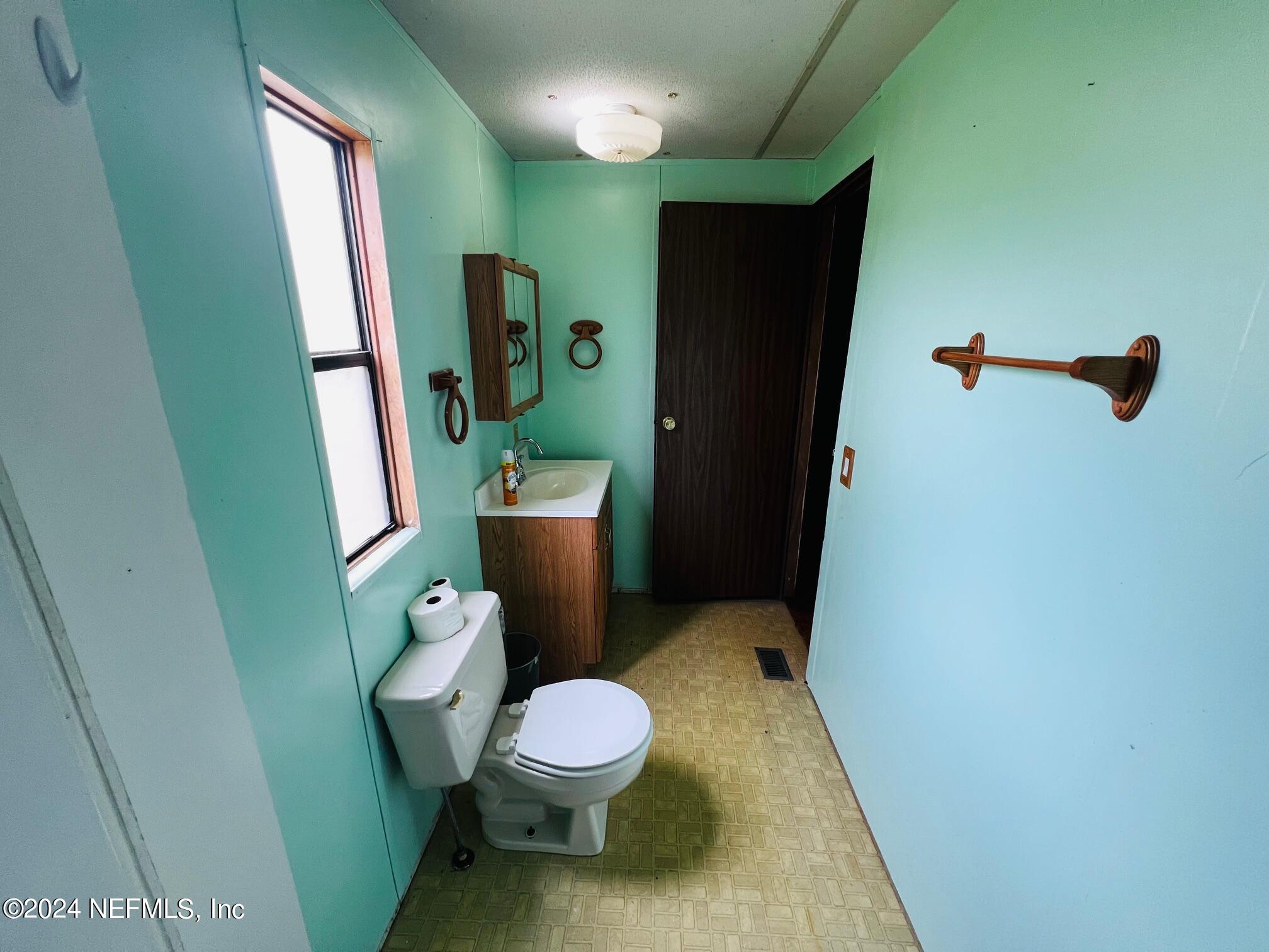 7635 Oak Forest Road Keystone Heights, FL 32656 - Photo 16 of 30 a bathroom with a toilet and a sink