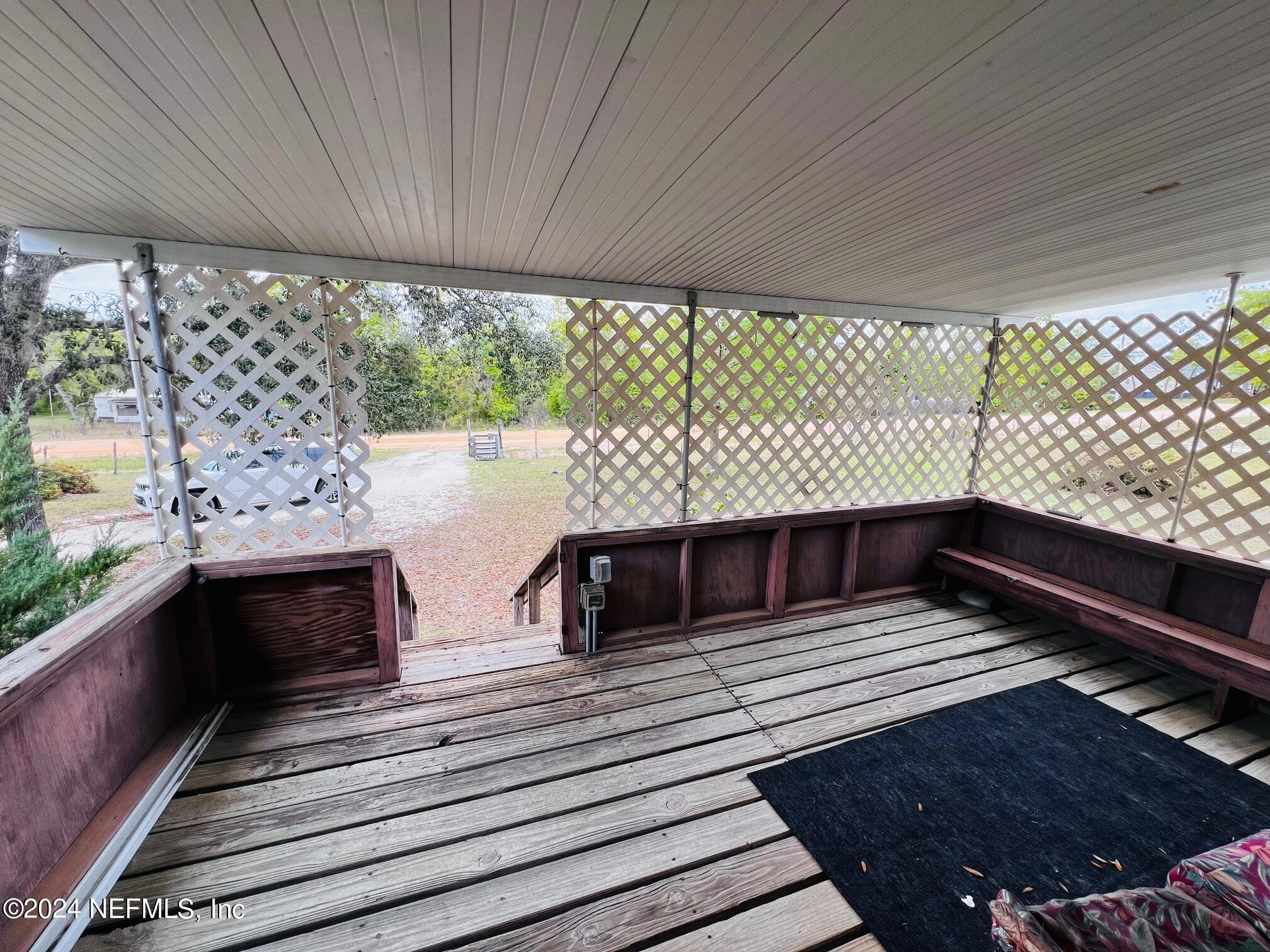 7635 Oak Forest Road Keystone Heights, FL 32656 - Photo 21 of 30 a view of balcony with wooden floor and outdoor seating