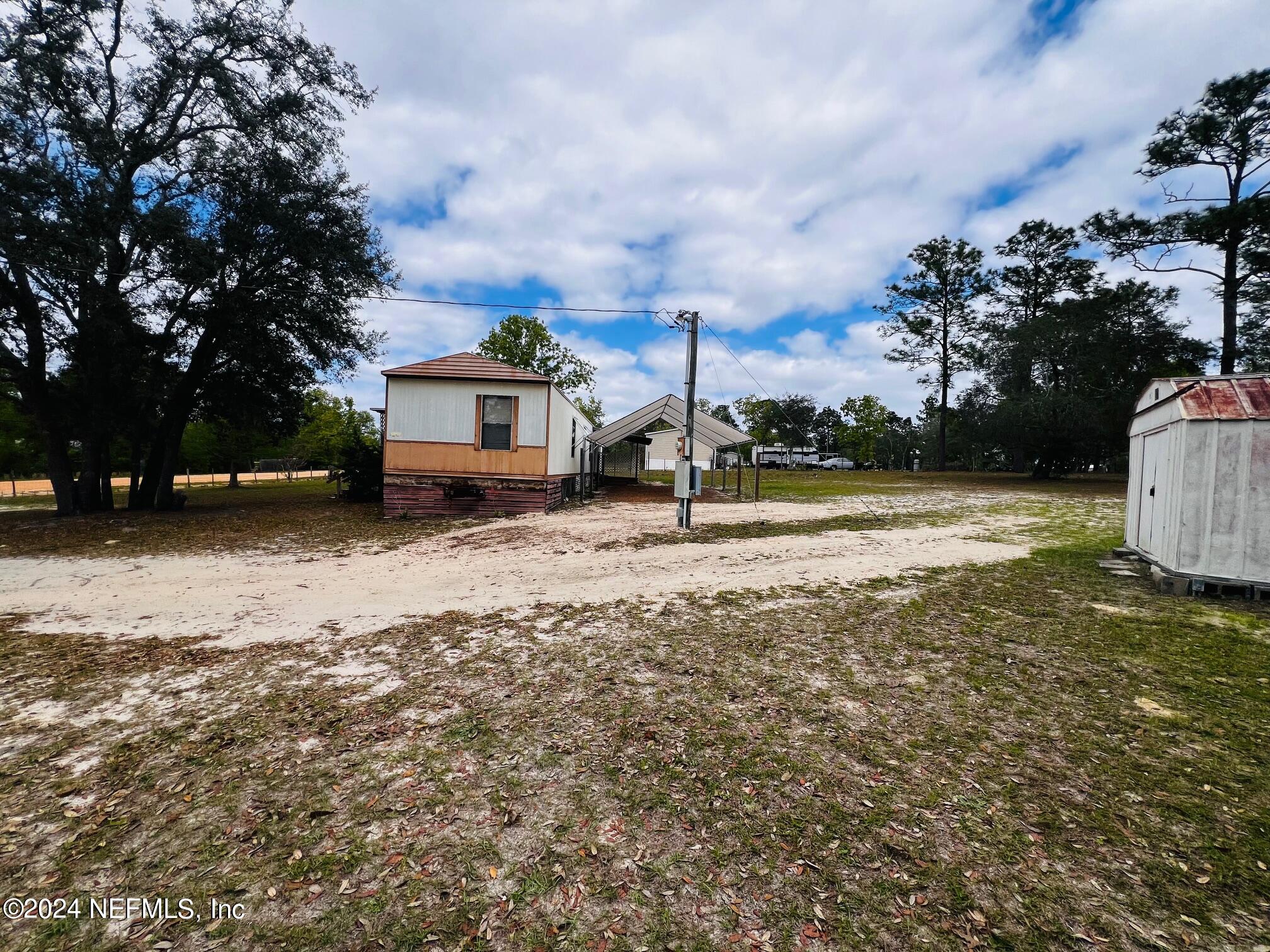7635 Oak Forest Road Keystone Heights, FL 32656 - Photo 22 of 30 a view of a house with a yard covered with snow
