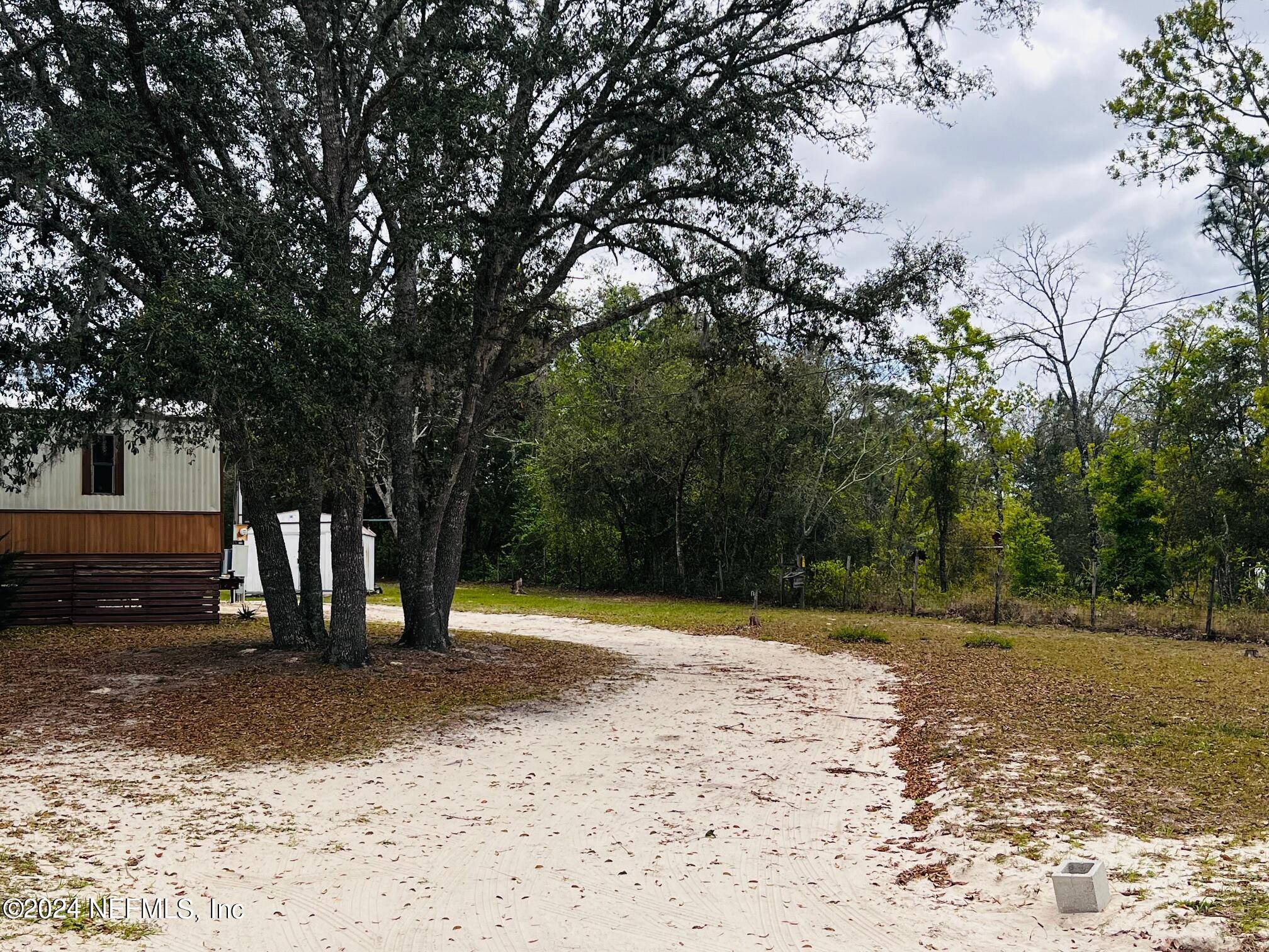 7635 Oak Forest Road Keystone Heights, FL 32656 - Photo 4 of 30 a view of outdoor space with deck and tree