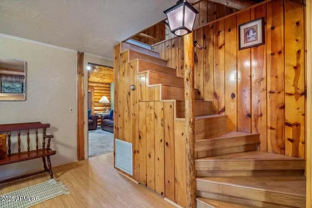 a view of a bathroom with wooden floor and glass door