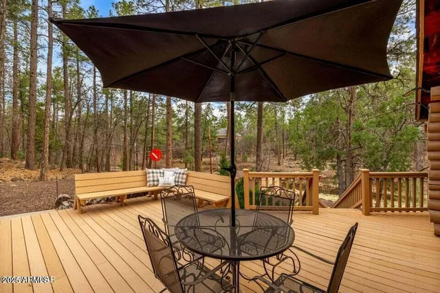 a patio with water view fountain with wooden floor and outdoor seating