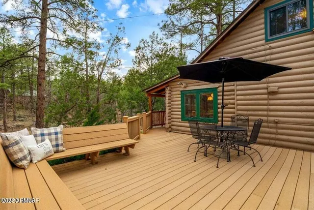 a roof deck with a table and chairs