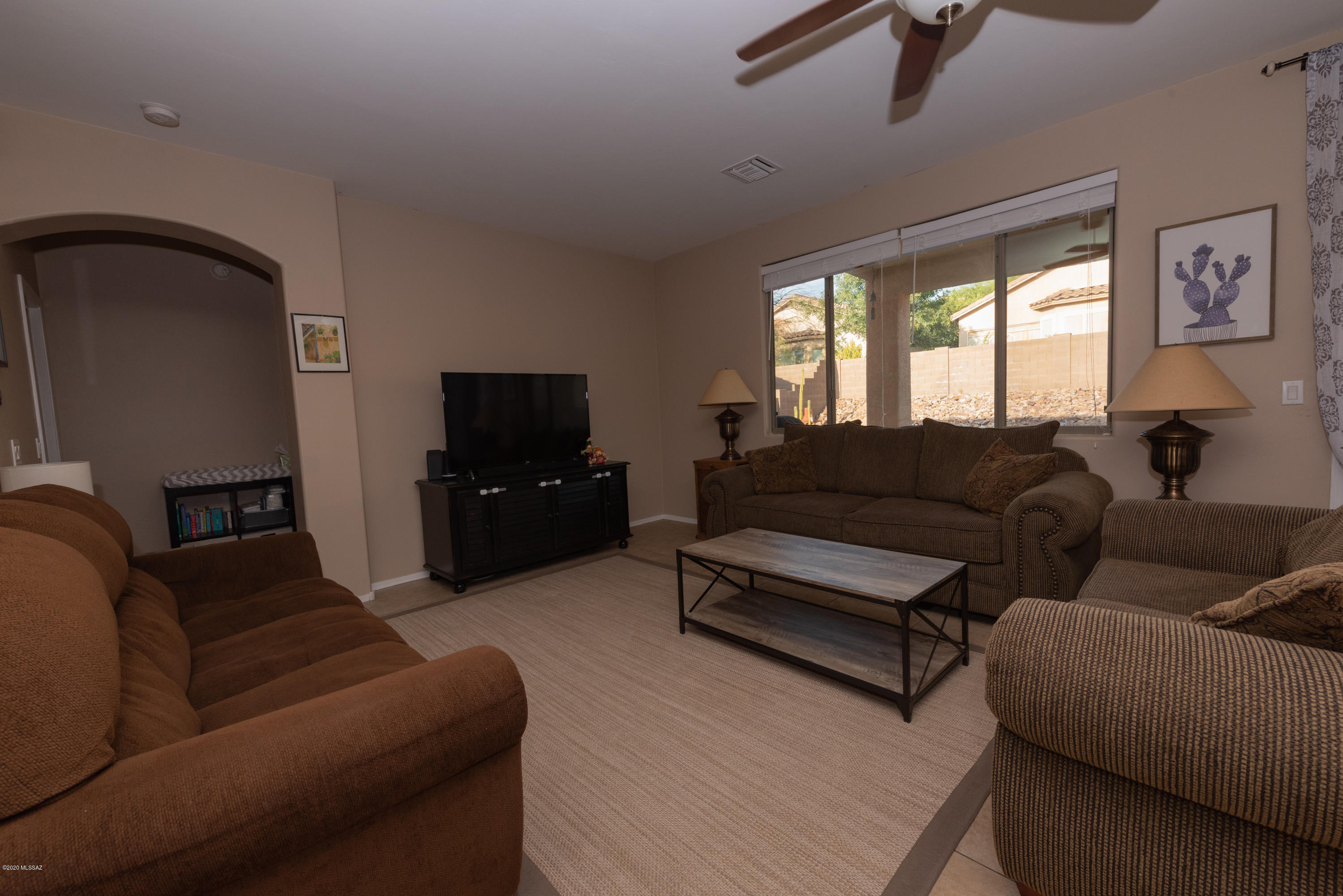 12910 Bloomington Loop Oro Valley, AZ 85755 - Photo 3 of 30 a living room with furniture and a flat screen tv