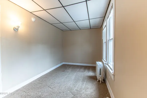 a view of entryway with window and wooden floor