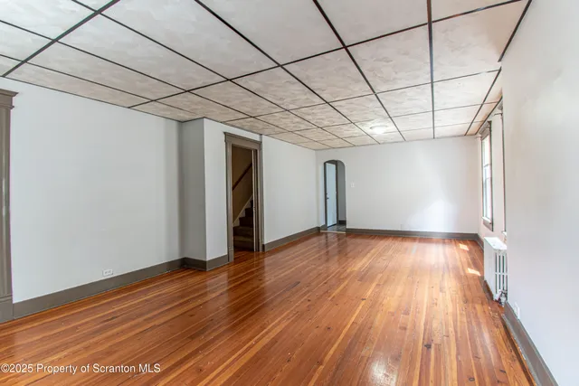 a view of a room with wooden floor
