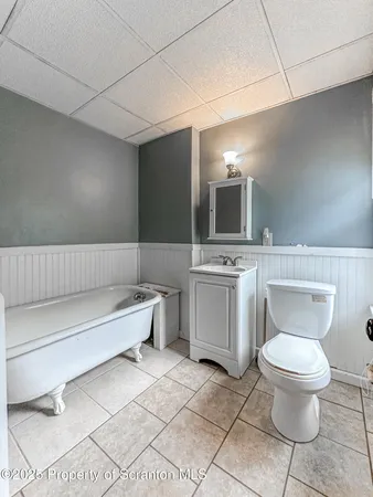 a bathroom with a toilet a sink and mirror