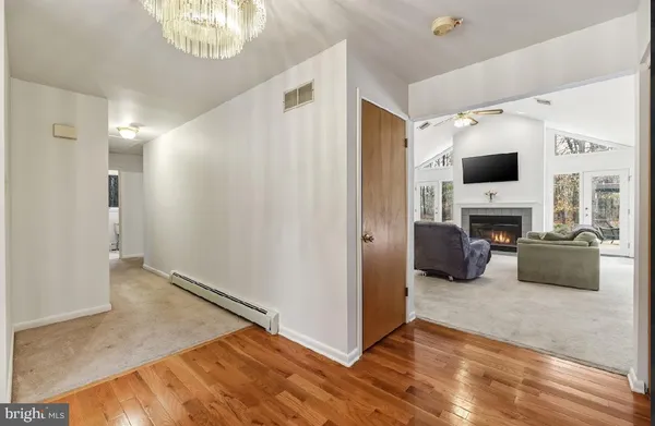 a kitchen with refrigerator a sink and wooden floor
