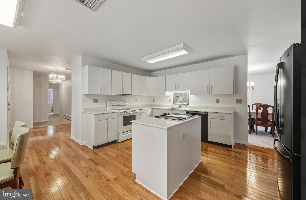 1159 Moss Mill Road Hammonton, NJ 08037 - Photo 13 of 31 a kitchen with refrigerator a sink and wooden floor