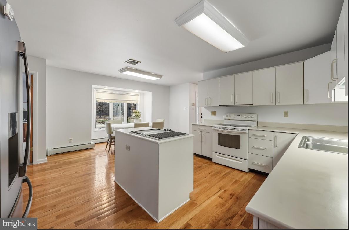 1159 Moss Mill Road Hammonton, NJ 08037 - Photo 14 of 31 a kitchen with a stove a sink and a refrigerator