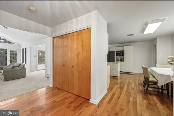 a kitchen with kitchen island white cabinets and refrigerator