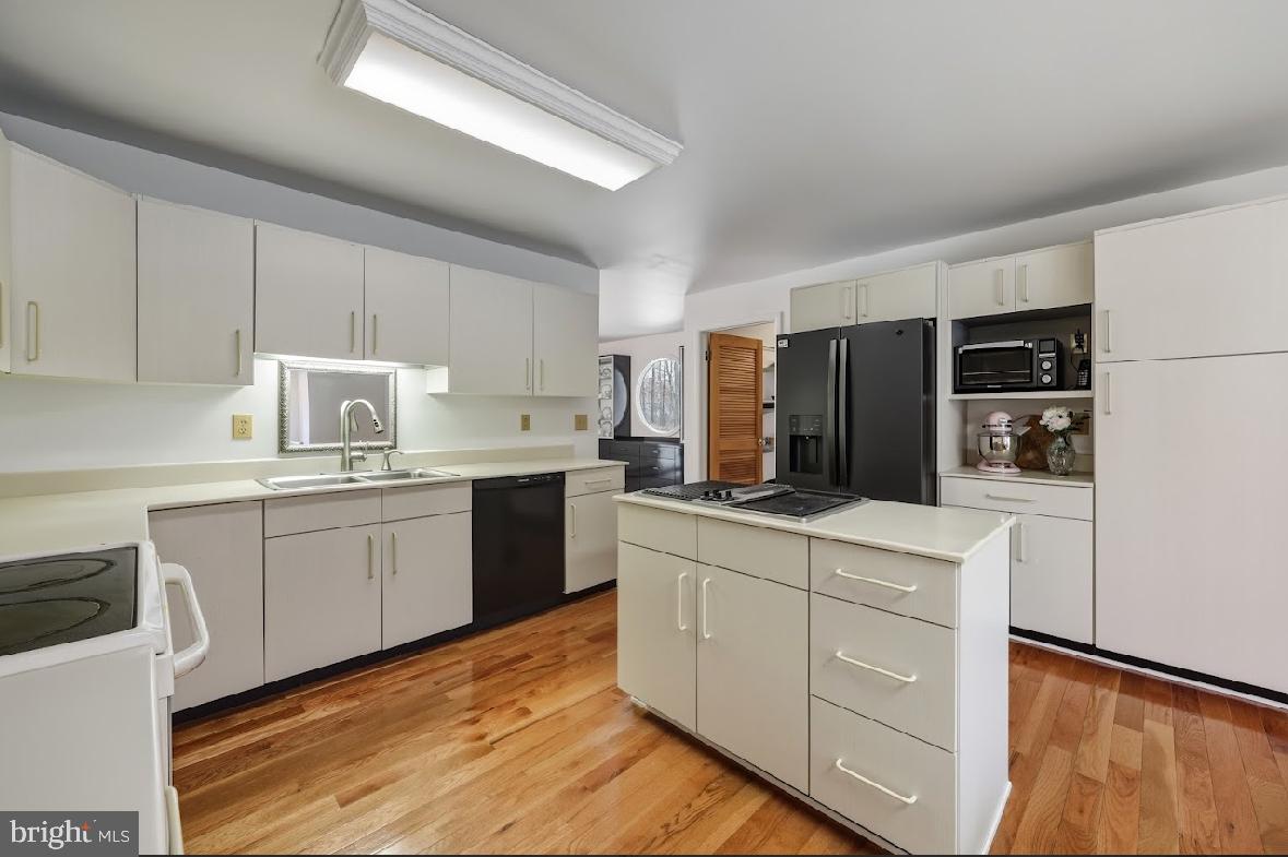 1159 Moss Mill Road Hammonton, NJ 08037 - Photo 10 of 31 a kitchen with kitchen island white cabinets and refrigerator