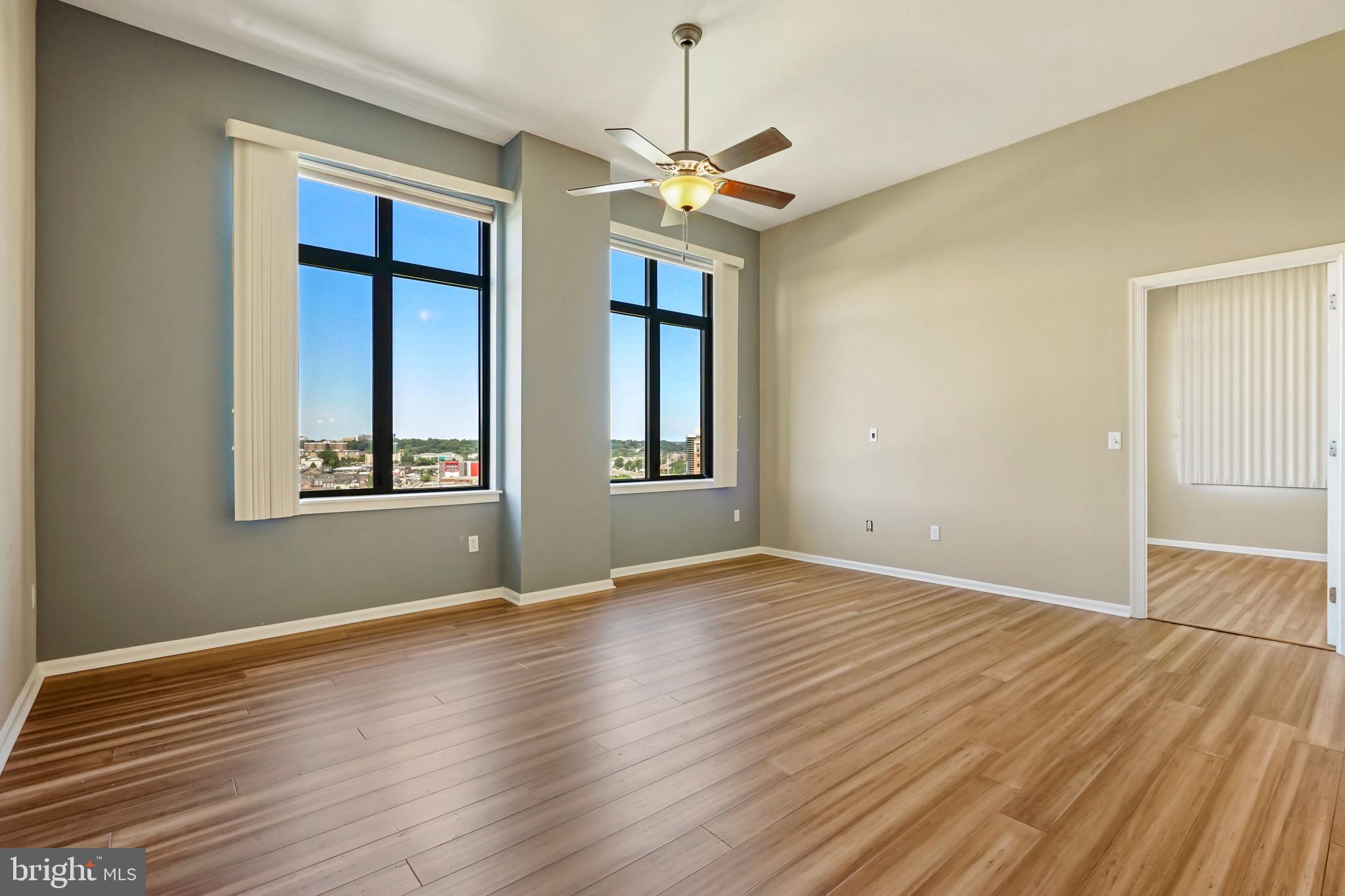2720 South Arlington Mill Drive, Unit 1102 Arlington, VA 22206 - Photo 12 of 28 a view of an empty room with window and wooden floor