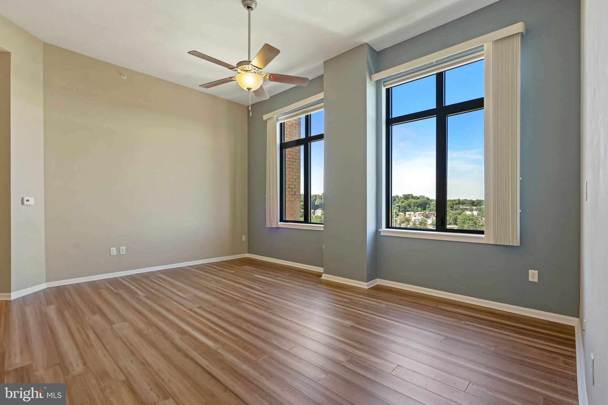 2720 South Arlington Mill Drive, Unit 1102 Arlington, VA 22206 - Photo 14 of 28 a view of an empty room with wooden floor and a window