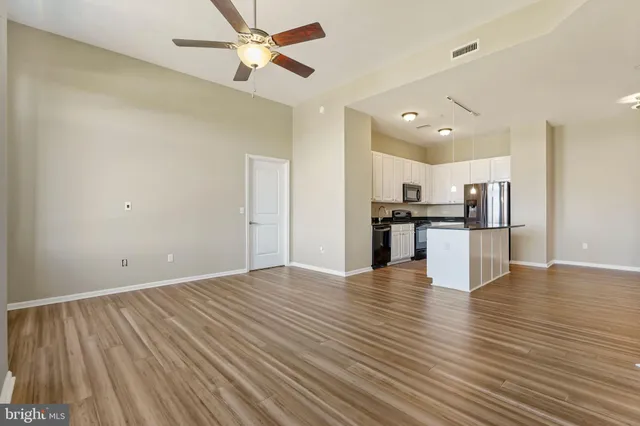 a view of kitchen with refrigerator microwave and stove