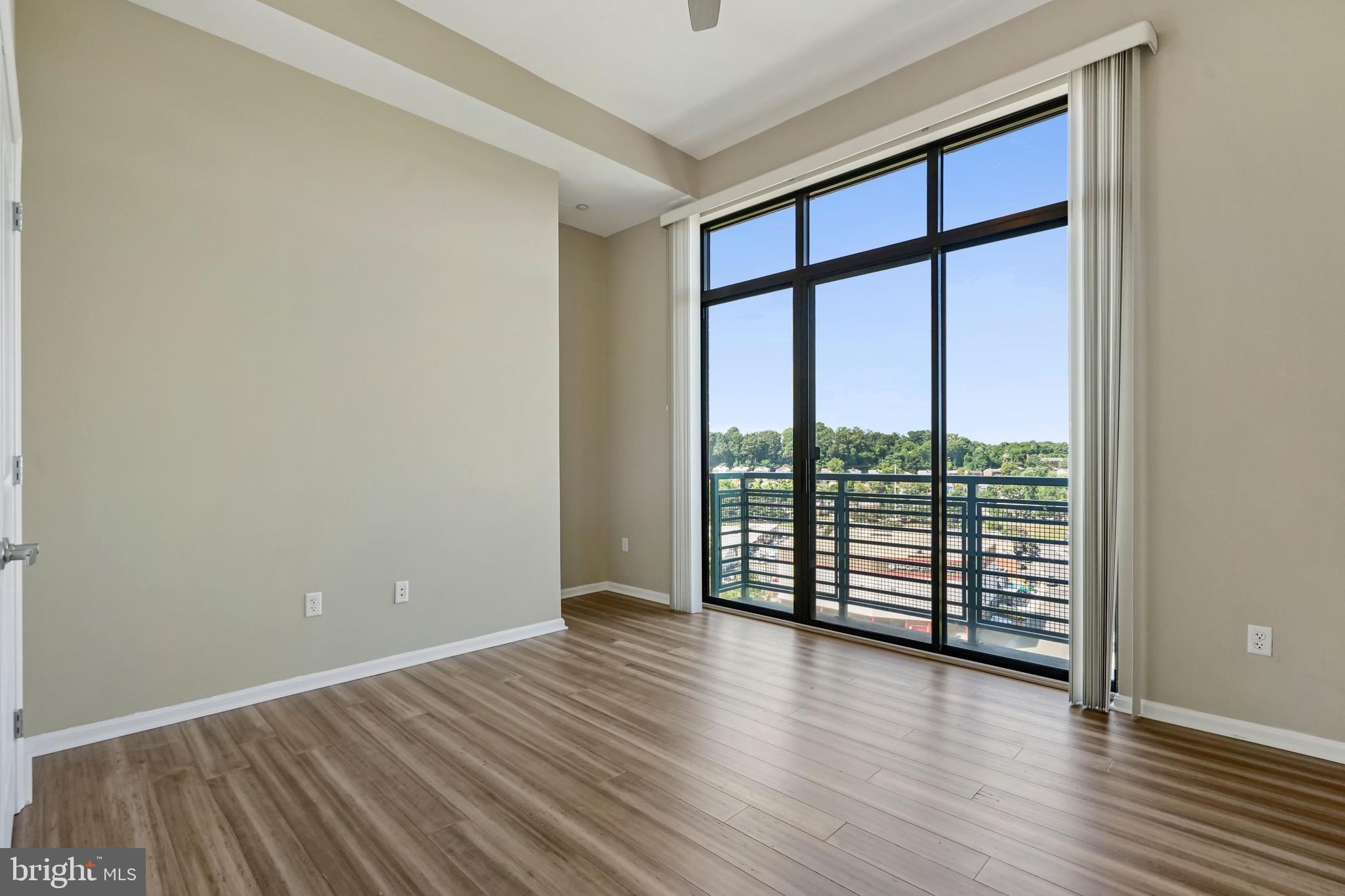 2720 South Arlington Mill Drive, Unit 1102 Arlington, VA 22206 - Photo 19 of 28 wooden floor in an empty room with a window