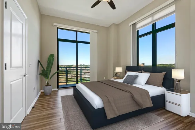 a bedroom with a large bed and a large window