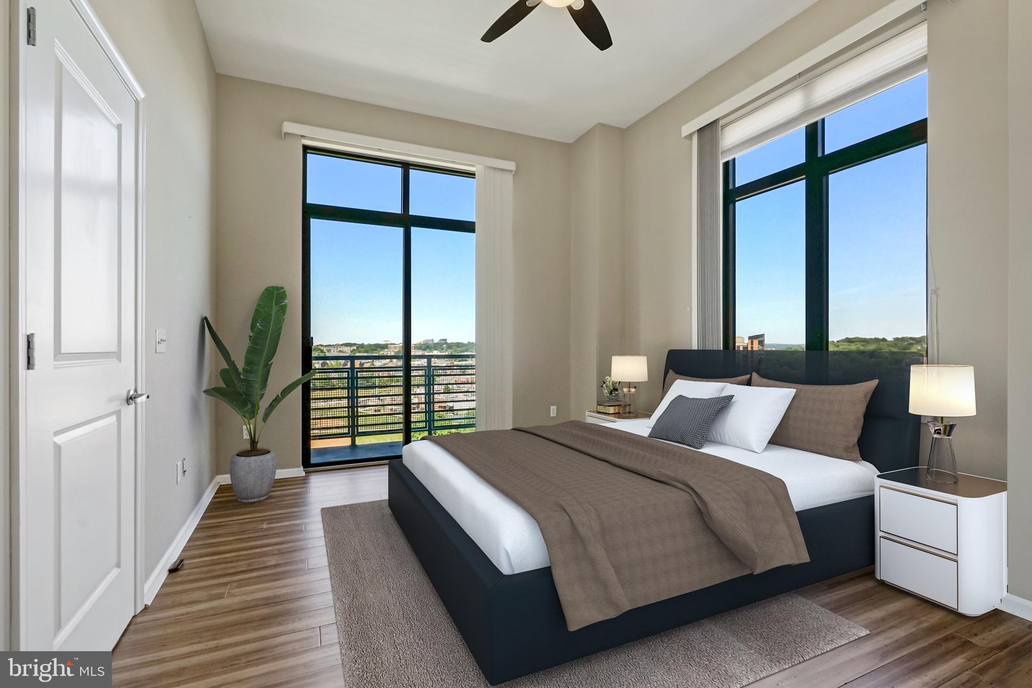 2720 South Arlington Mill Drive, Unit 1102 Arlington, VA 22206 - Photo 3 of 28 a bedroom with a large bed and a large window