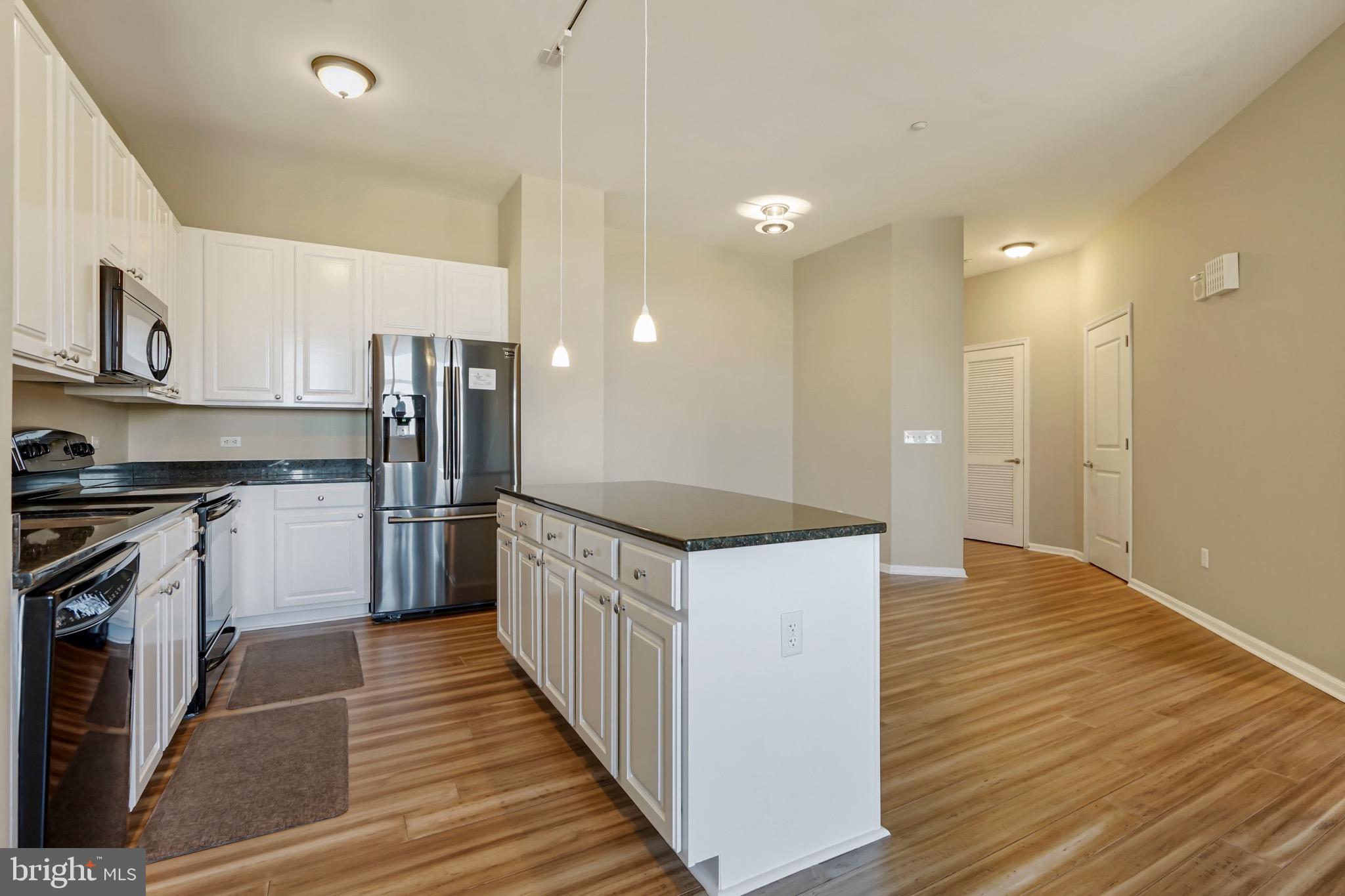 2720 South Arlington Mill Drive, Unit 1102 Arlington, VA 22206 - Photo 7 of 28 a kitchen with stainless steel appliances a stove and a refrigerator