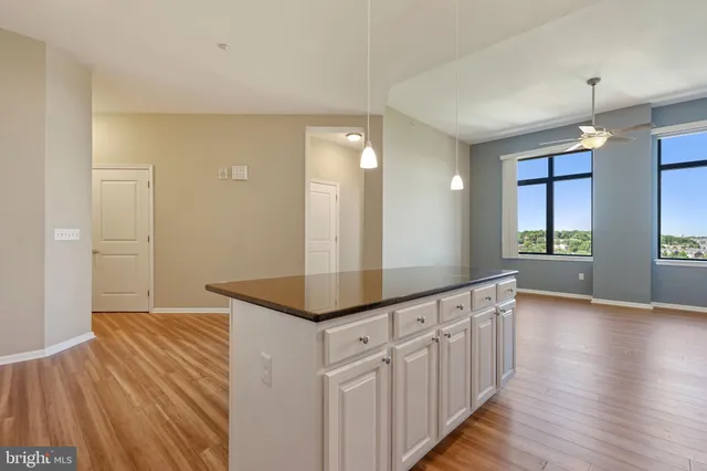 a bathroom with granite countertop a sink and a mirror