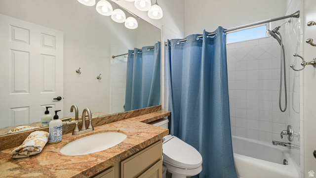 11128 South Barrett Pk Circle Sandy, UT 84092 - Photo 21 of 36 Bathroom featuring a vanity with an integrated sink and stone-finish countertop, a panel door, overhead lighting, a mirror, and a tub-shower combination with white tile surround