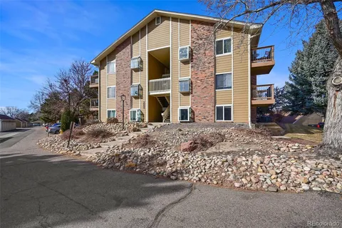 a front view of a building with a yard